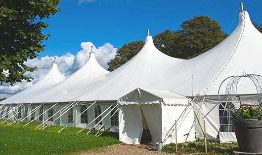 a row of portable toilets placed outdoors for attendees of a event in Castle Shannon